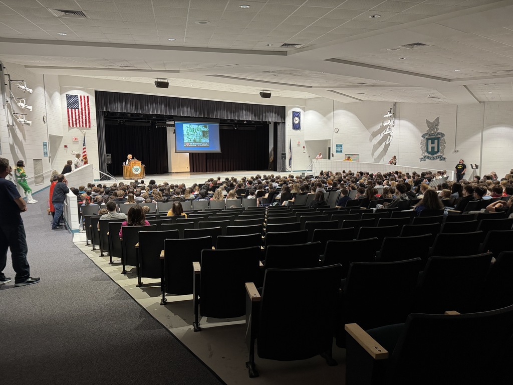 Auditorium filled with students listening to a presentation