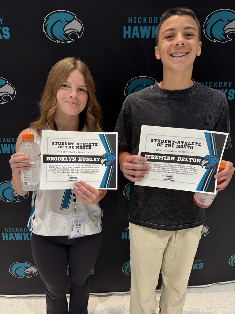 Two students proudly holding certificates and being honored as the Student-Athletes of the Month