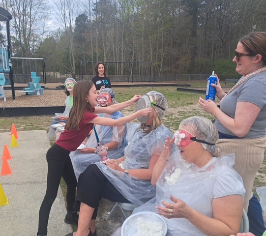 student pieing teacher in the face 