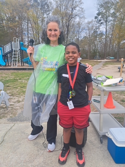 student receiving medal for raising the most money