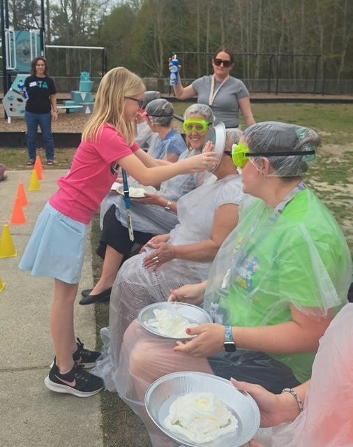 student pieing teacher in the face 