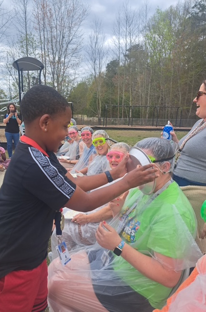 student pieing teacher in the face 