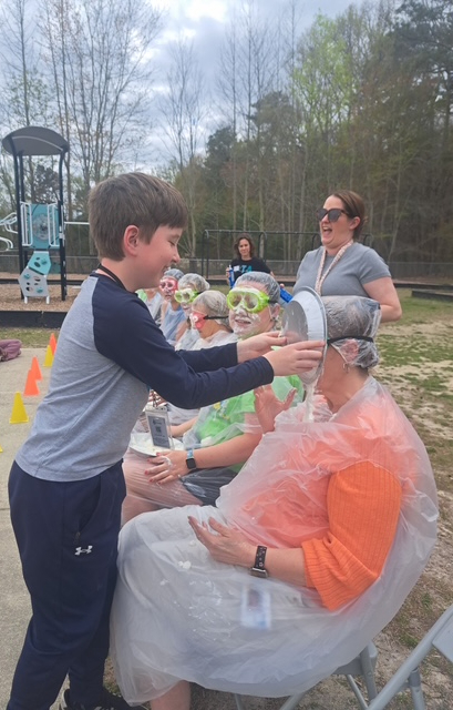student pieing teacher in the face 
