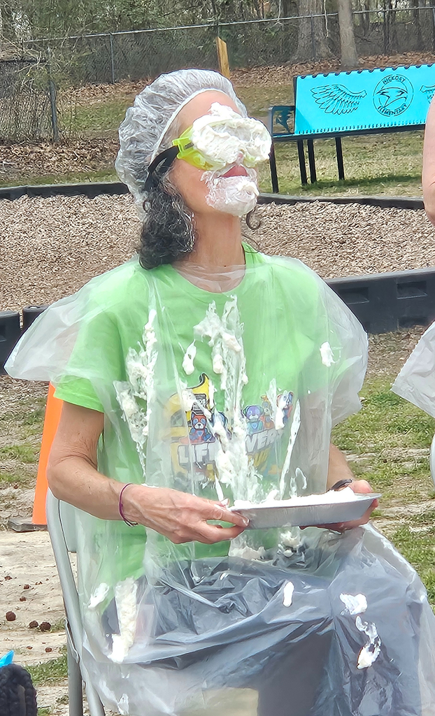 PE teacher with Whipped cream  on her face from being pied 