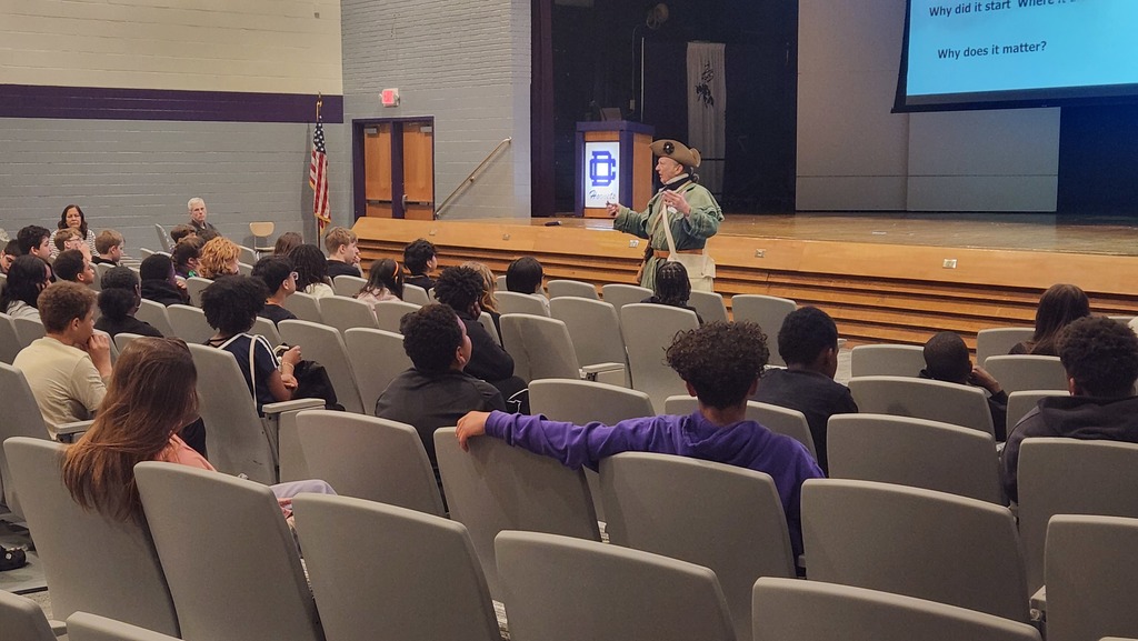 A revolutionary war re-enactor presenting the Battle of Great Bridge to seventh graders. 