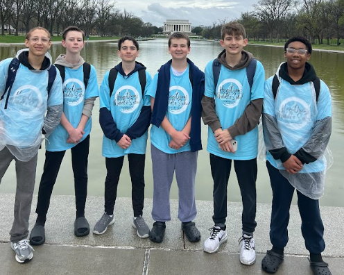 A close-up of a small group of students looking at memorial. 