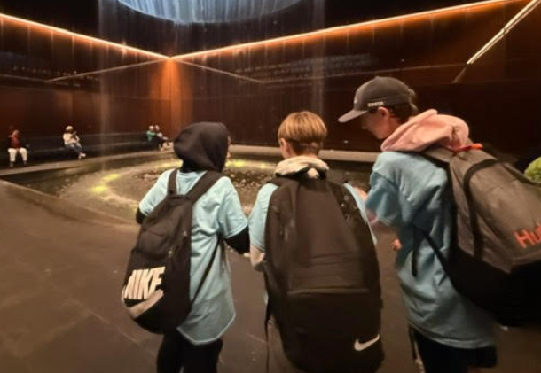 A close-up of a small group of students looking at an exhibit. 