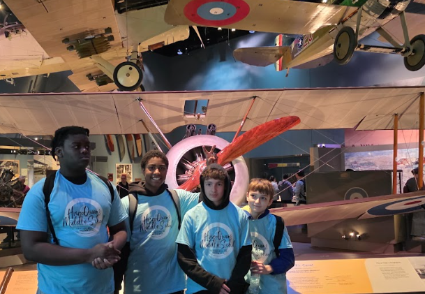 A close-up of a small group of students looking at an exhibit inside a Smithsonian museum