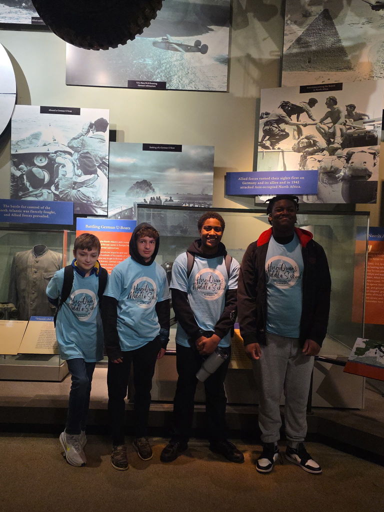 A close-up of a small group of students looking at an exhibit