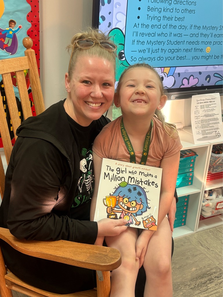A student poses with their parent, a guest reader, in Ms. Shinn’s 2nd grade classroom.