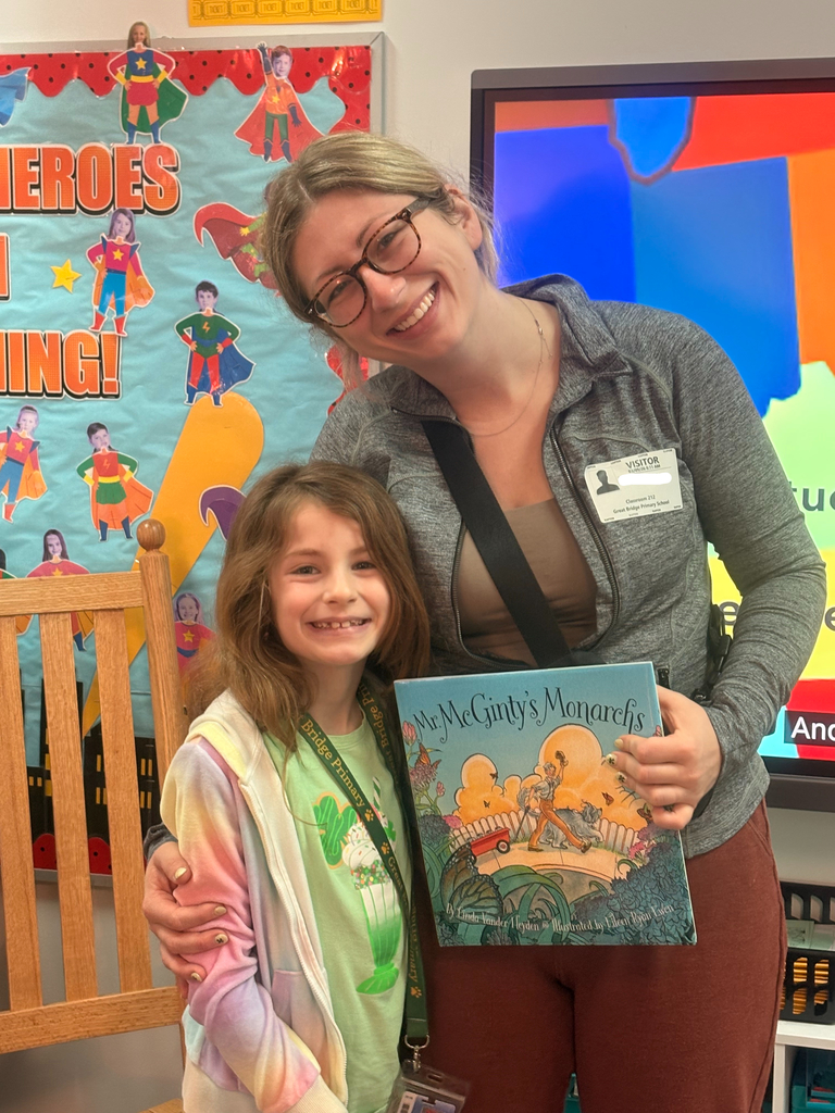 A student and their parent pose together after a guest reader visit in Ms. Shinn’s class.