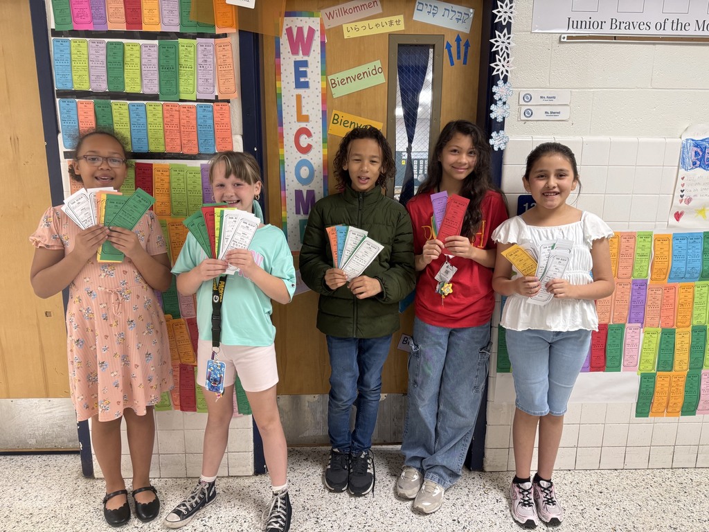 Koontz's Class in the hallway in front of the Book Spine display of the books they read.