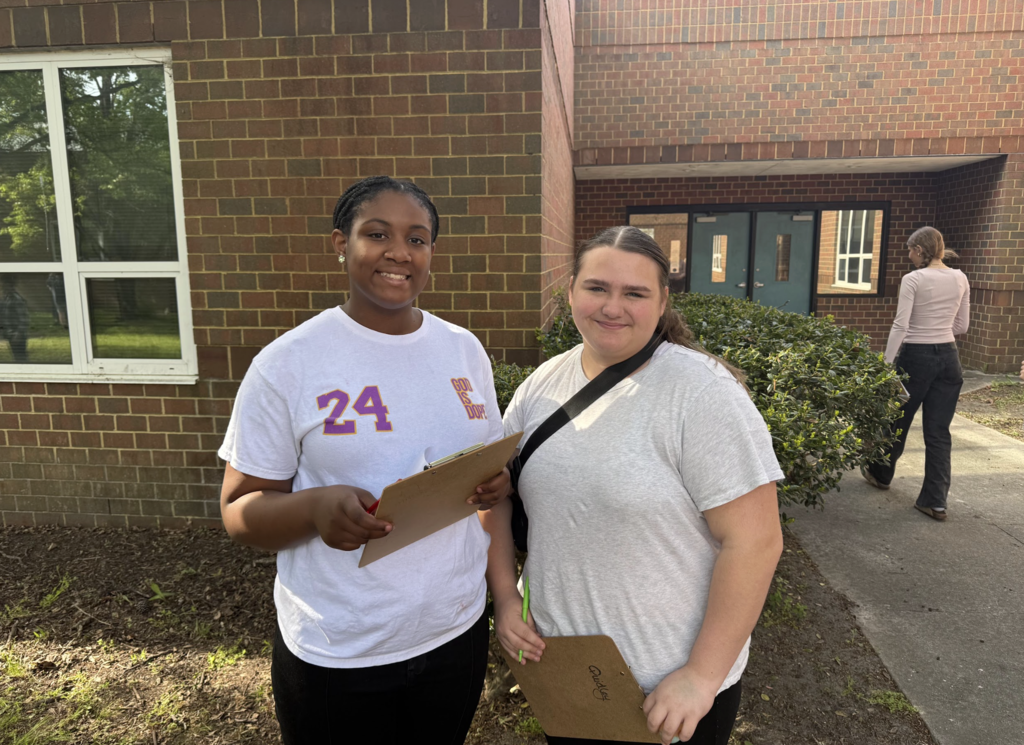 Students participating in an egg hunt outside in the courtyard