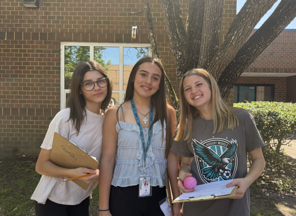 Students participating in an egg hunt outside in the courtyard