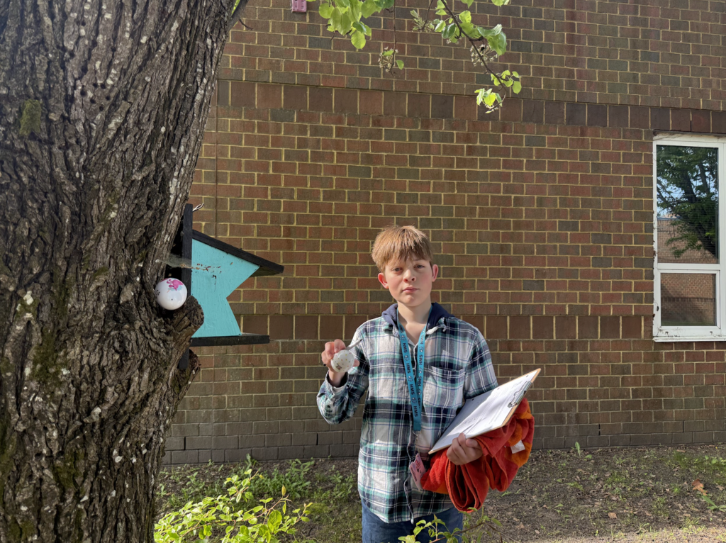Students participating in an egg hunt outside in the courtyard