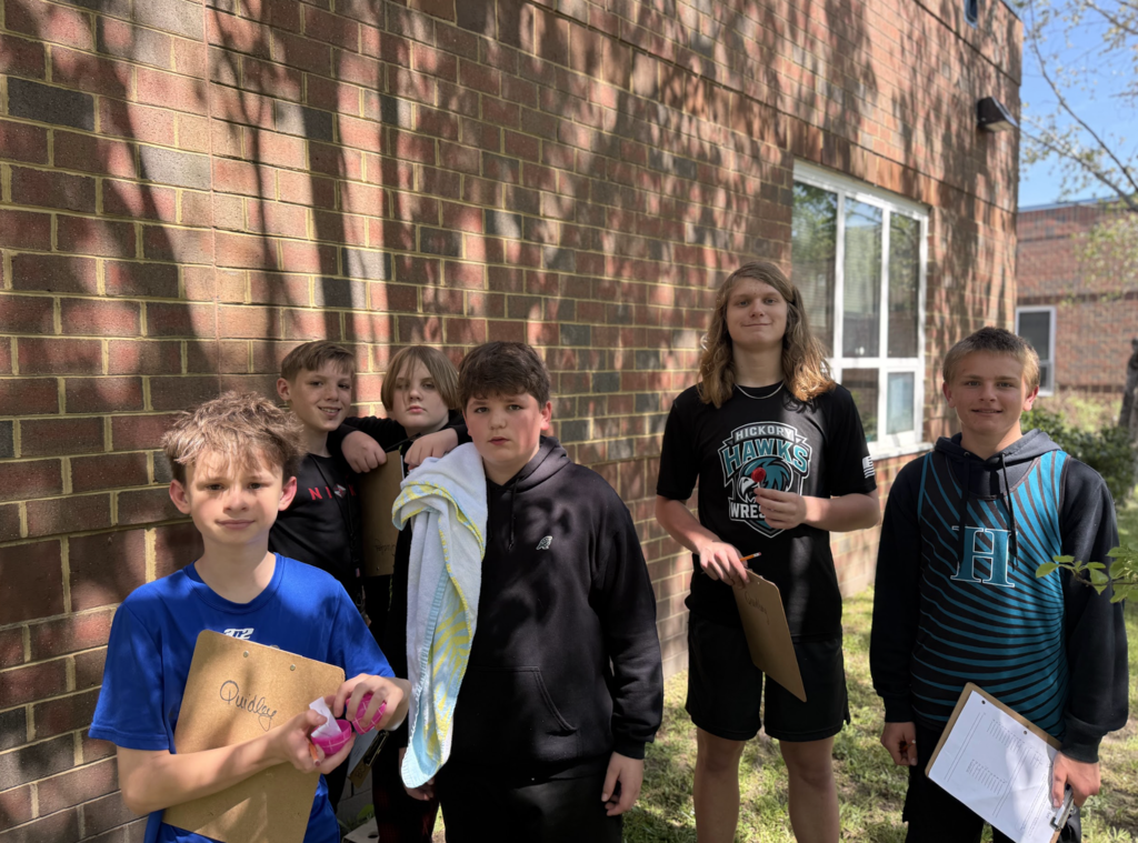 Students participating in an egg hunt outside in the courtyard