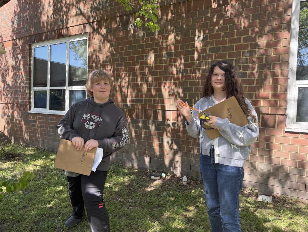 Students participating in an egg hunt outside in the courtyard