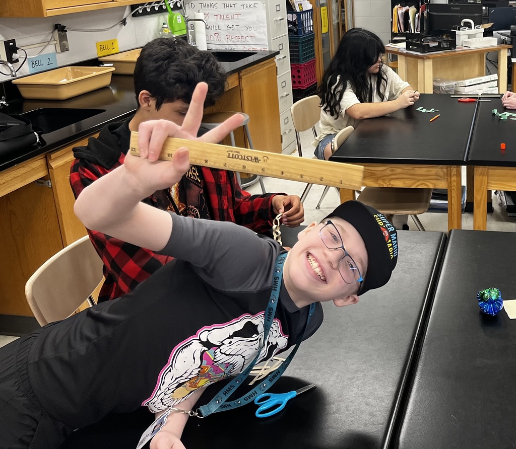 students working in a small group to create a paper chain