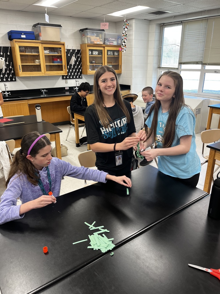 students working in a small group to create a paper chain