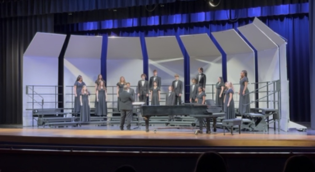 DCHS Choral students on stage performing during their District Assessment.