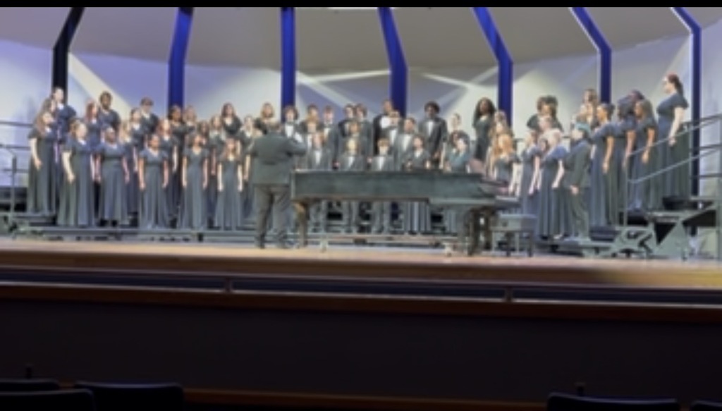 DCHS Choral students on stage performing during their District Assessment.