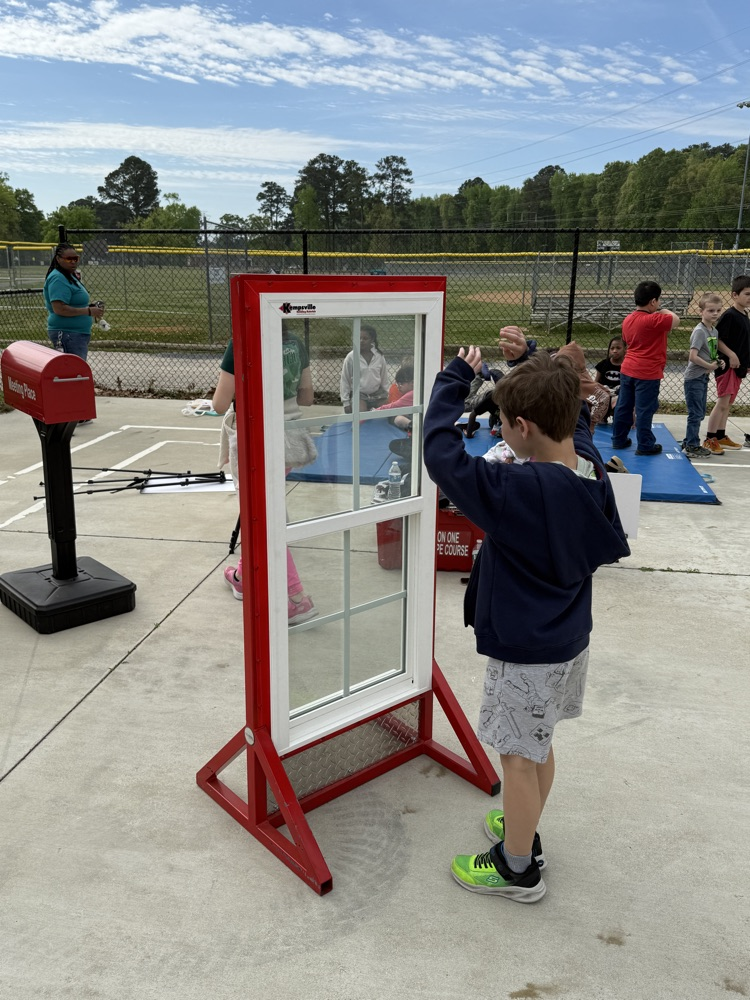 kids modeling waving to notify firefighters in case of a fire.