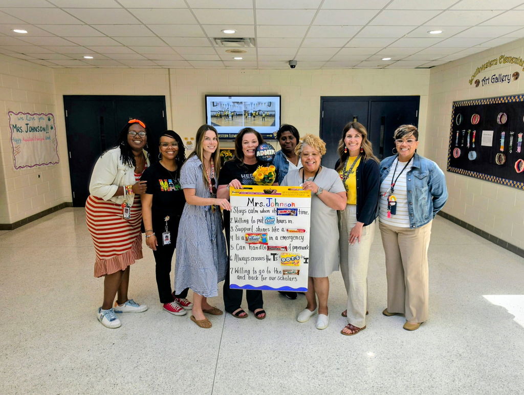 a group of teachers and the assistant principal with a sign showing appreciation
