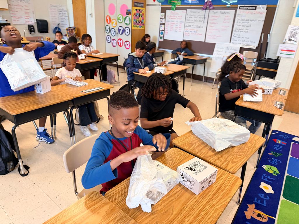 students with books and prizes