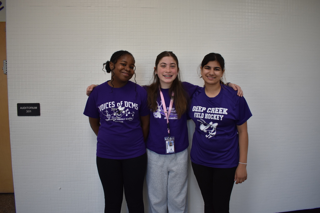 Three students wearing their purple to celebrate the Month of the Military Family.