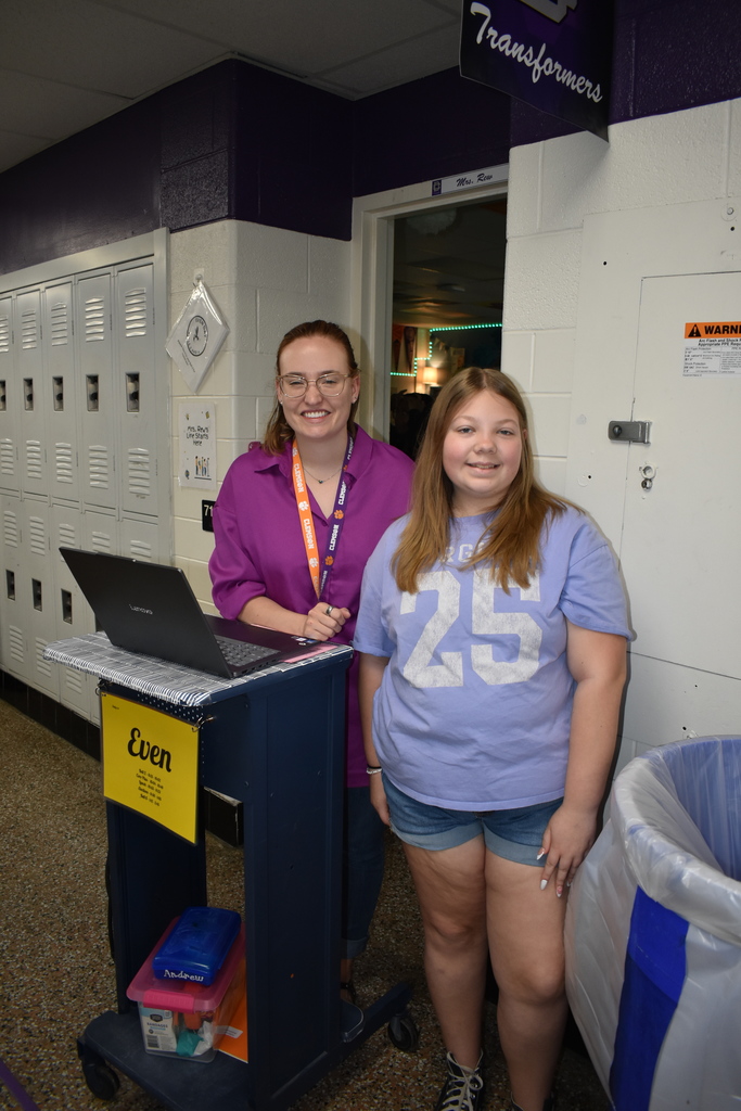 A teacher and a student wearing their purple to celebrate the Month of the Military Family.