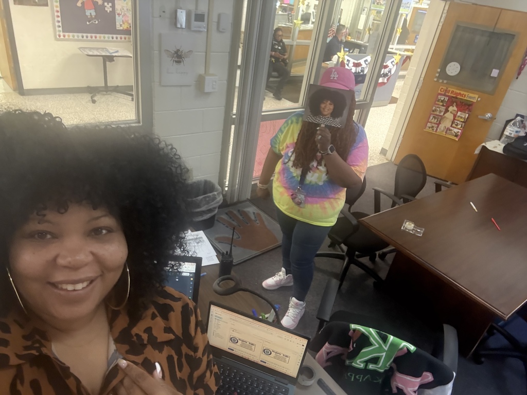 Mrs Battle posing with a staff member holding up her Mrs. Battle fan