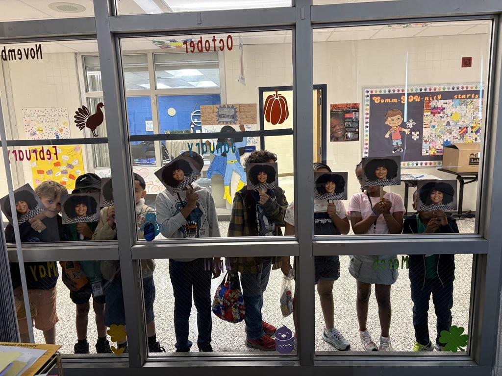 students standing at the office window with face fans over their faces