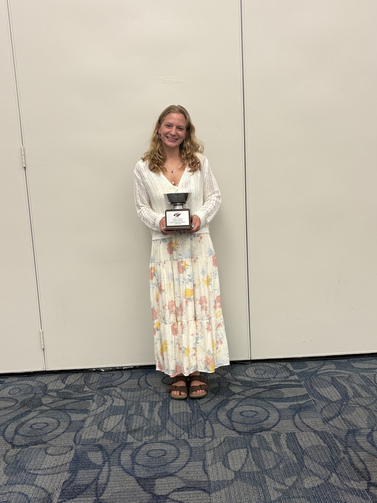 Sydney Holbach holding trophy after being named the most outstanding female athlete for swim and dive by the Chesapeake Sports Club! 