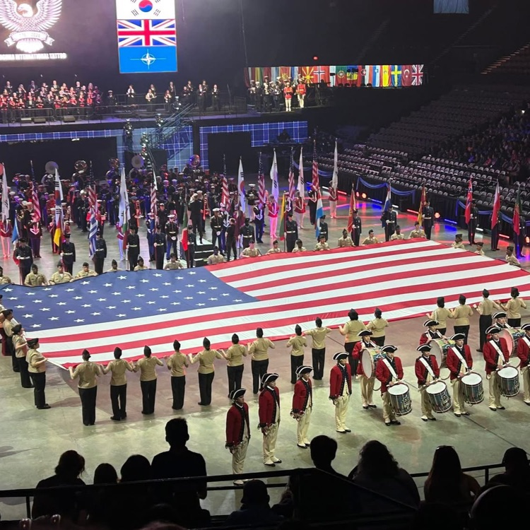 Band members presenting the US flag.