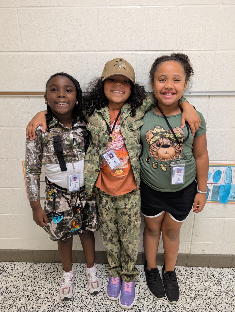 students posing in camo outfits