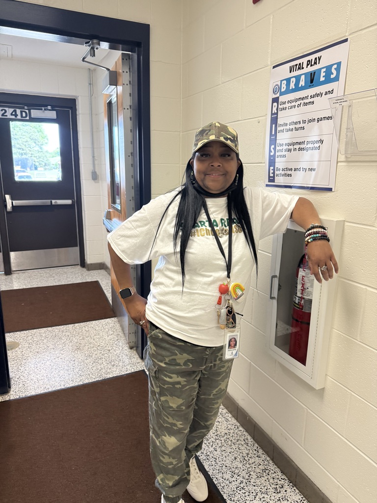 staff member posing in camo outfit