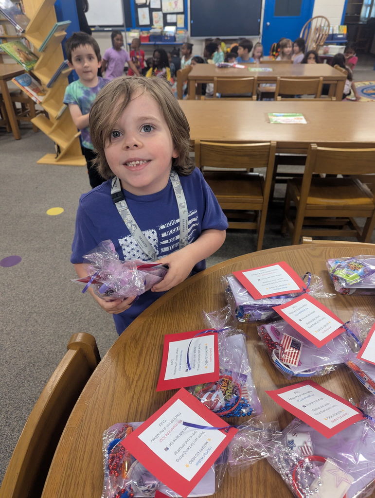 Student picking up treat bag.