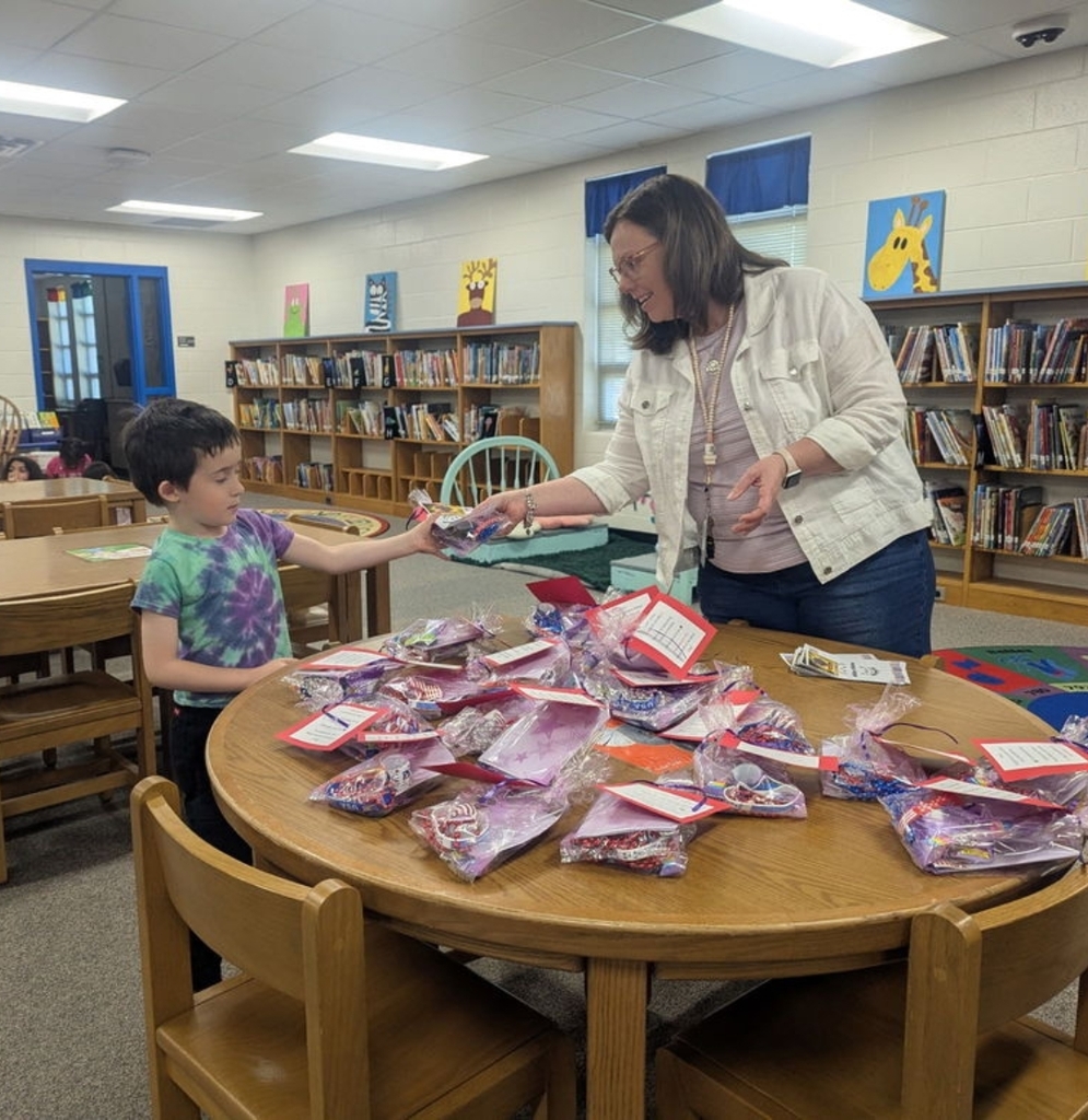 Student receiving treat bag.
