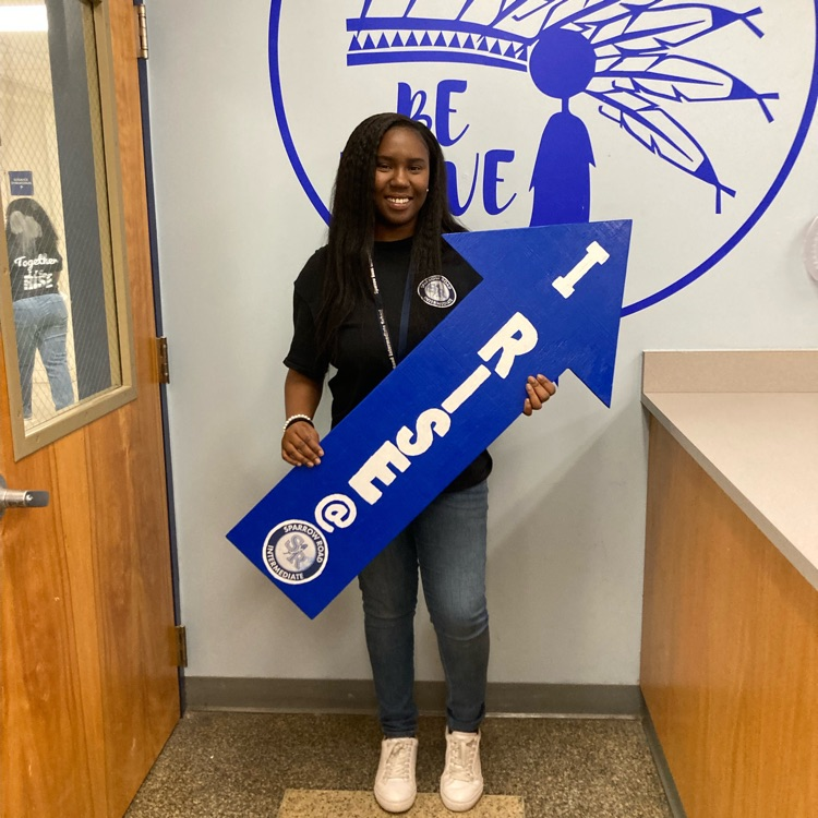 Ms. Clarke holding up the “I rise” arrow. 