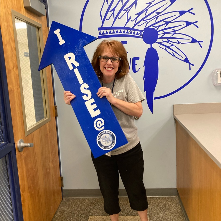 Ms. Gilmore holding up the “I rise” arrow. 