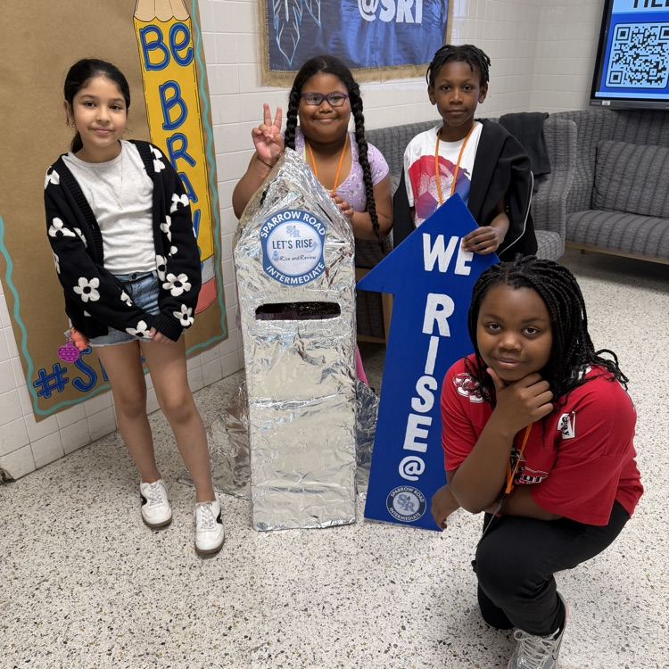 students with the We RISE arrow and the RISE and Review rocket. 