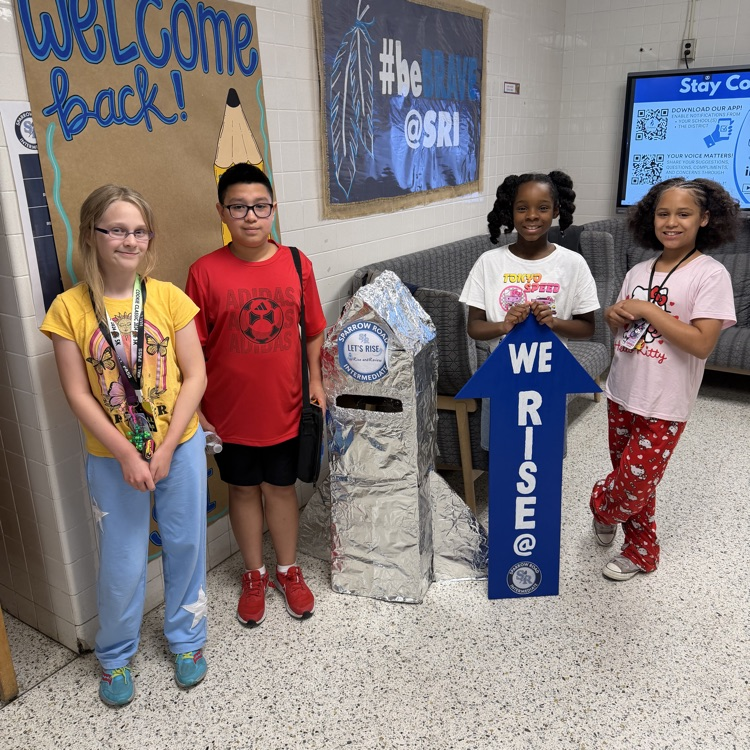 students with the We RISE arrow and the RISE and Review rocket. 