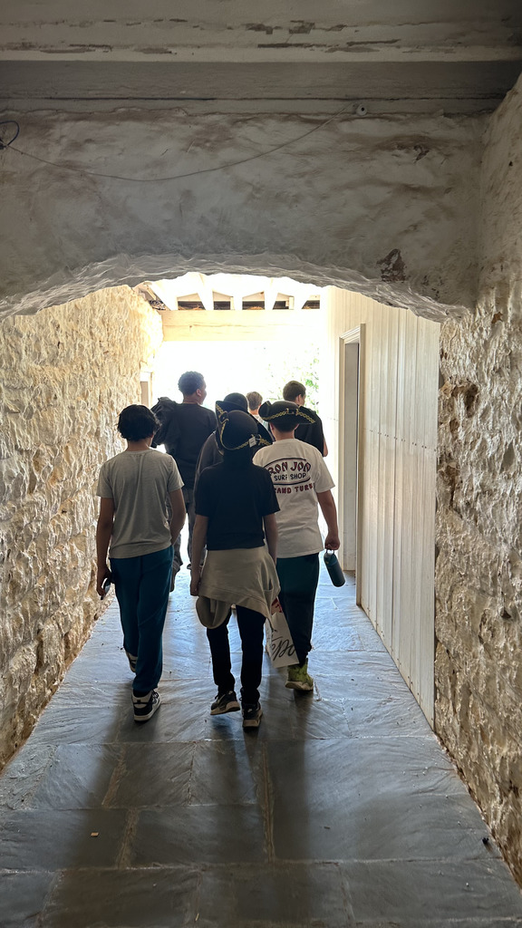 A group of students walking through the stone passageways of Monticello