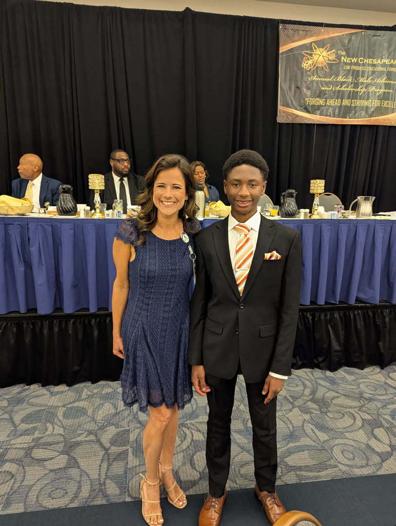 assistant principal happily standing with our honored student