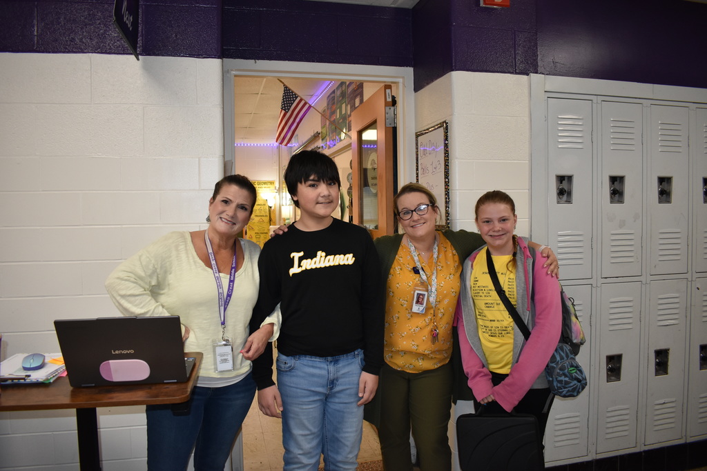 Two teachers and two students wearing a yellow to celebrate the month of the military child
