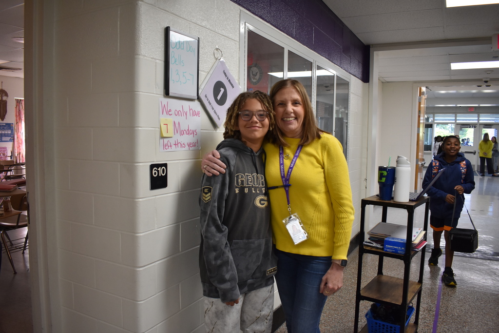 A teacher and a student wearing a yellow to celebrate the month of the military child