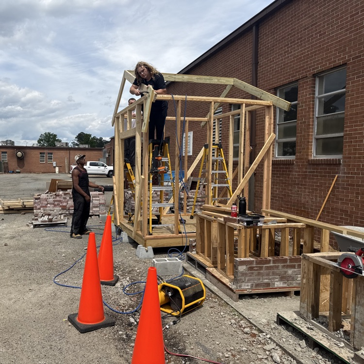 building trades students framing a shed
