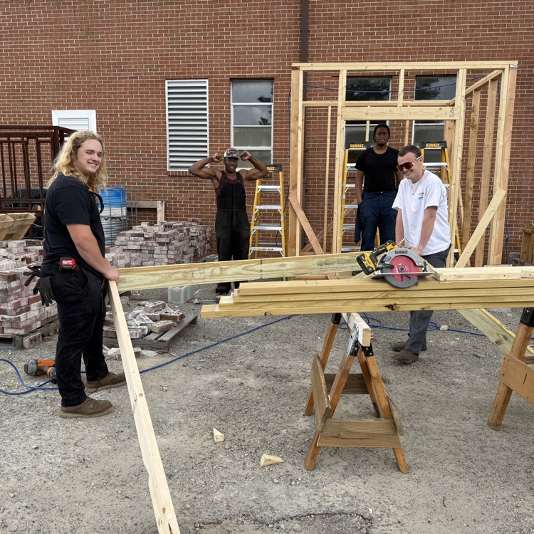building trades students framing a shed