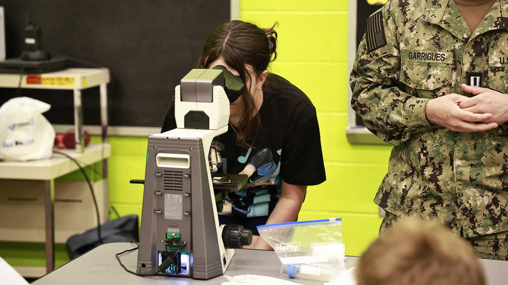 A student using a microscope