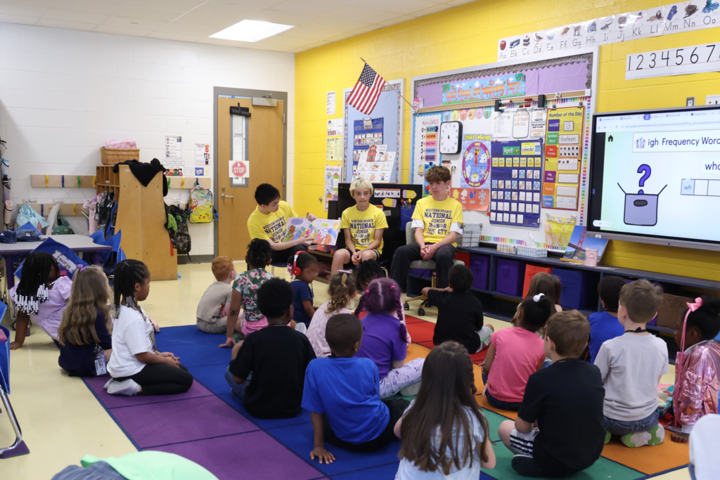 students excitedly  read to  primary students